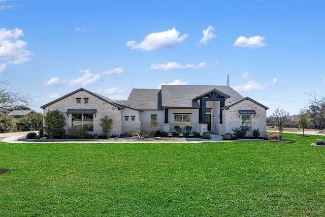 view of front of home featuring stone siding and a front yard