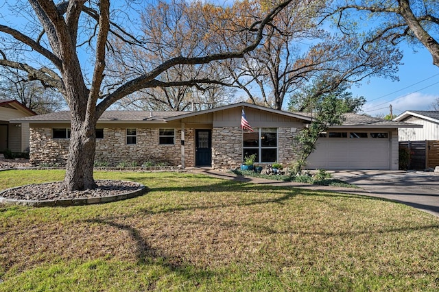 view of front of house featuring stone siding, concrete driveway, a garage, and a front yard