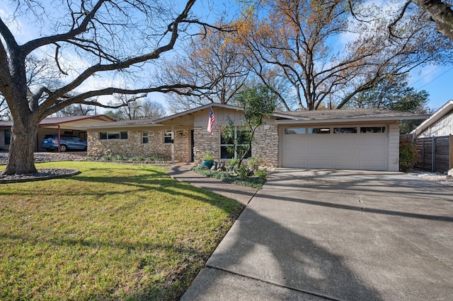 view of front of home with fence, concrete driveway, a front yard, stone siding, and an attached garage