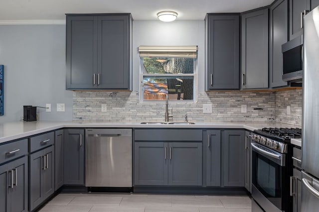 2709 Cascade Dr, Austin, TX 78757 - kitchen with appliances with stainless steel finishes, backsplash, ornamental molding, light countertops, and gray cabinetry