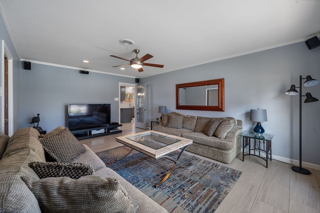 living room featuring visible vents, crown molding, baseboards, recessed lighting, and a ceiling fan