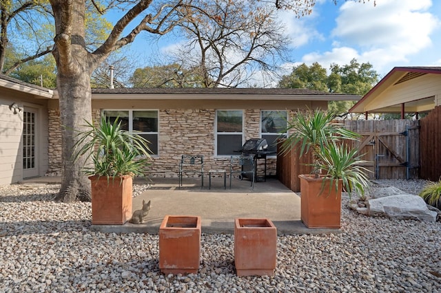2709 Cascade Dr, Austin, TX 78757 - back of house featuring stone siding and a patio area