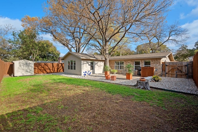 back of house featuring a patio, a fenced backyard, a lawn, and an outdoor structure