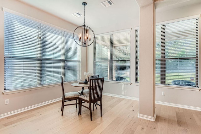 dining area featuring a chandelier, visible vents, baseboards, and light wood-style floors