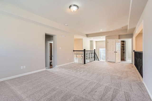 empty room featuring recessed lighting, visible vents, baseboards, and light colored carpet