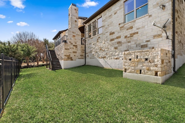 view of yard featuring stairway and fence