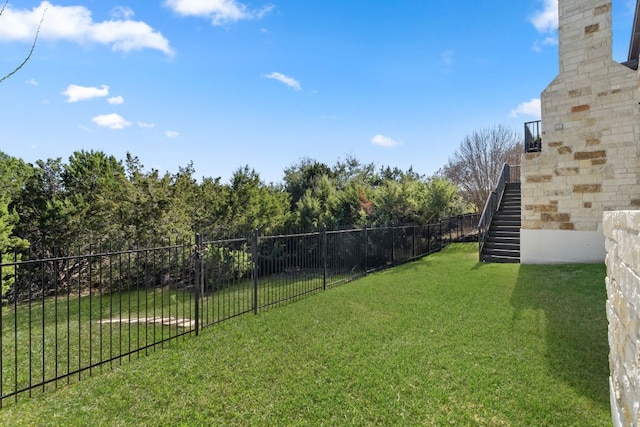 view of yard with stairway and fence