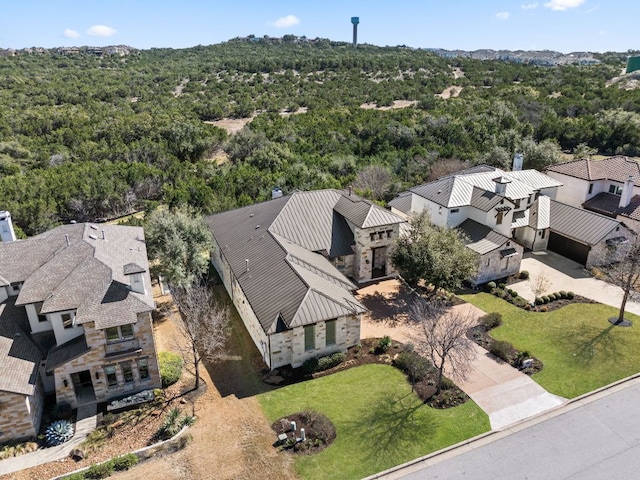 drone / aerial view featuring a forest view and a residential view