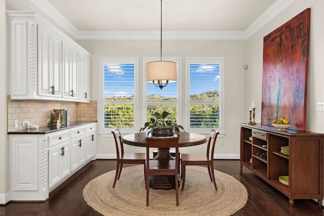 dining area featuring plenty of natural light, dark wood-type flooring, and ornamental molding