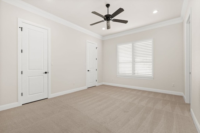 unfurnished bedroom featuring crown molding, baseboards, and light carpet