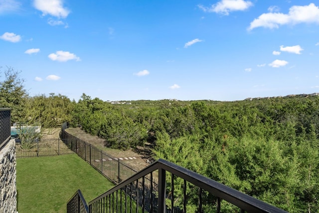 view of yard featuring a view of trees and fence