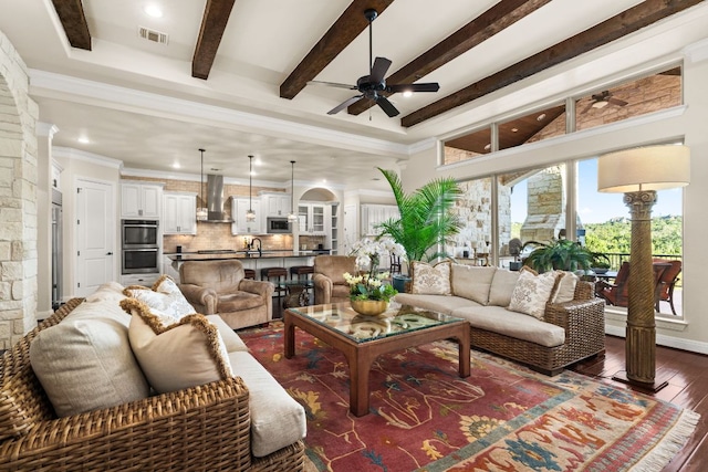 908 Crestone Stream Dr, Austin, TX 78738 - living room featuring a ceiling fan, dark wood-style floors, recessed lighting, beam ceiling, and ornate columns