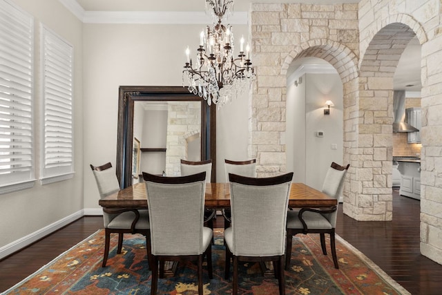 dining space featuring baseboards, arched walkways, ornamental molding, dark wood-type flooring, and a notable chandelier