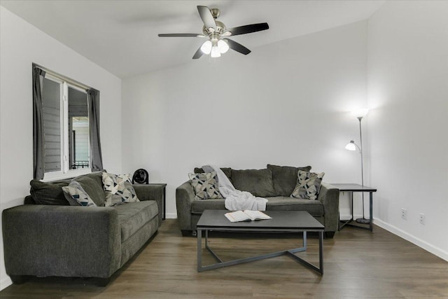 living area with baseboards, a ceiling fan, and wood finished floors