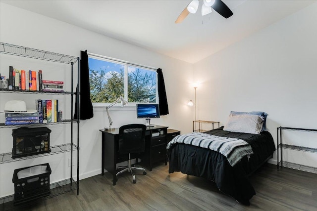 bedroom with ceiling fan, baseboards, and wood finished floors