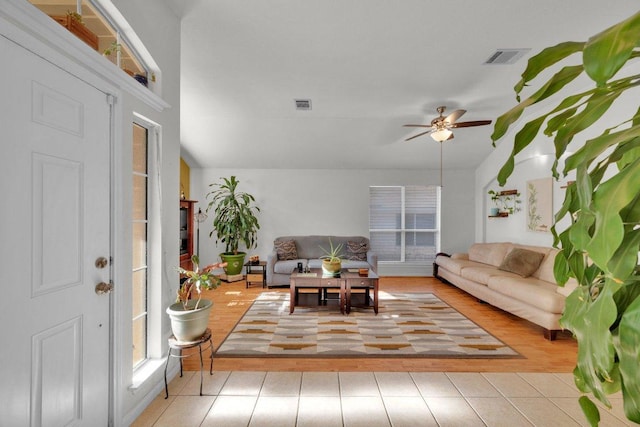 tiled living area featuring visible vents and ceiling fan