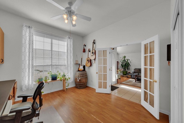 office area with french doors, baseboards, light wood-type flooring, and ceiling fan