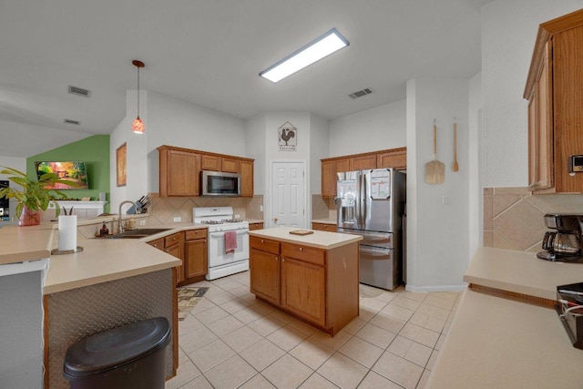 kitchen featuring a peninsula, visible vents, appliances with stainless steel finishes, and a sink