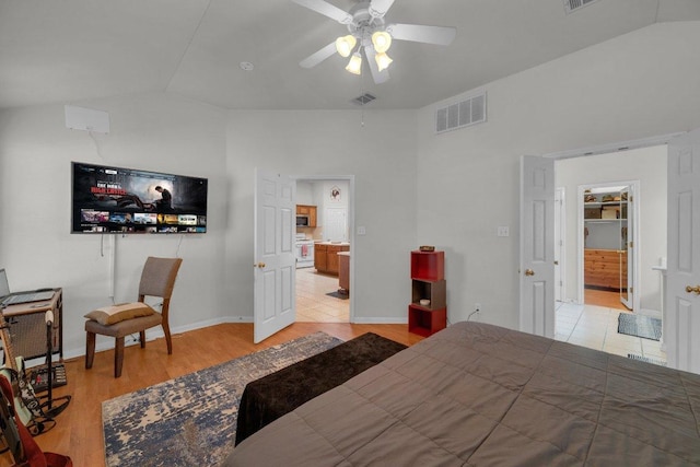 bedroom with lofted ceiling, light wood-style floors, visible vents, and ceiling fan