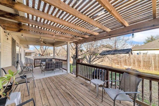 deck featuring outdoor dining area, a fenced backyard, a pergola, and ceiling fan