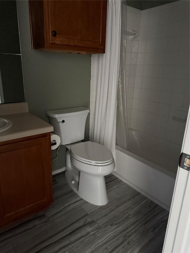 bathroom featuring shower / bath combination with curtain, toilet, and vanity