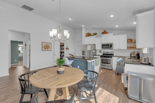 dining room featuring visible vents, baseboards, recessed lighting, an inviting chandelier, and light wood-style floors