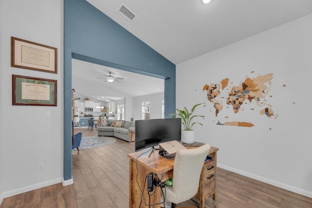 office featuring visible vents, wood finished floors, baseboards, lofted ceiling, and ceiling fan