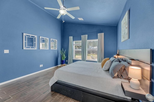 bedroom with ceiling fan, baseboards, wood finish floors, and vaulted ceiling