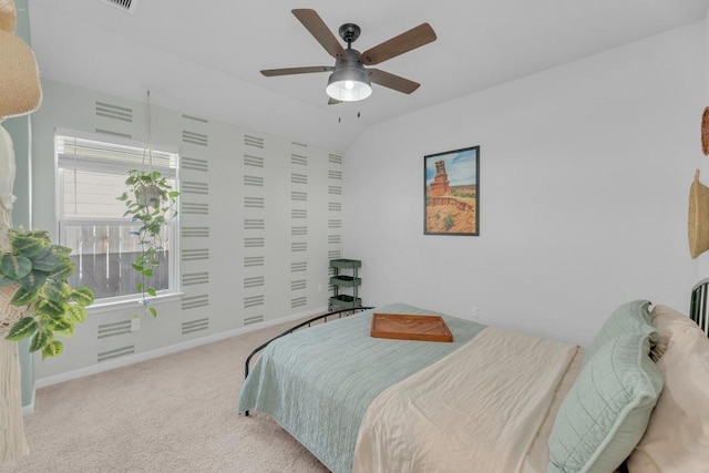 bedroom featuring baseboards, ceiling fan, carpet flooring, and vaulted ceiling