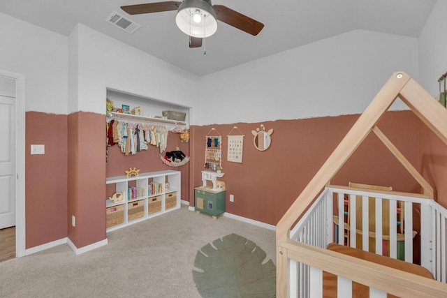 carpeted bedroom featuring baseboards, visible vents, ceiling fan, vaulted ceiling, and a nursery area