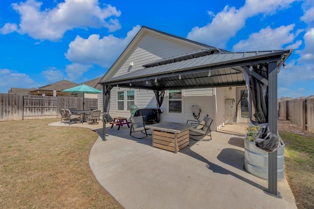 view of patio with a gazebo, an outdoor fire pit, and a fenced backyard