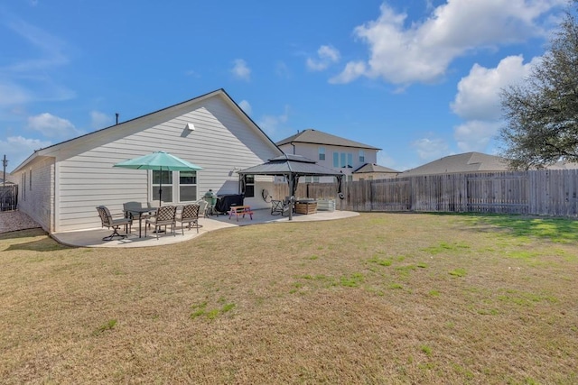 back of house featuring a gazebo, a patio area, a yard, and fence