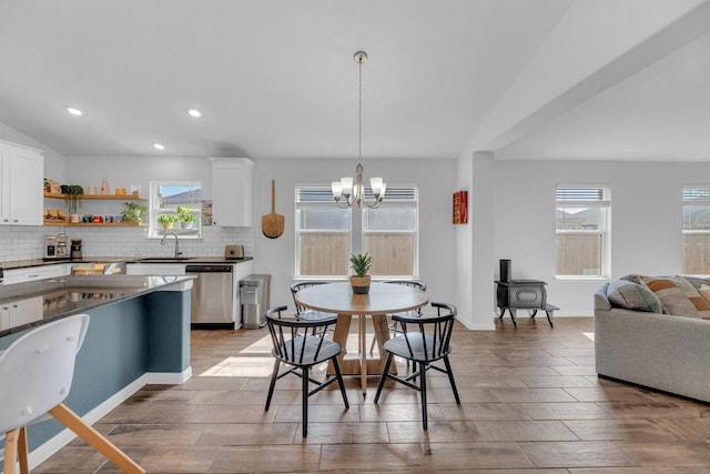 dining space featuring a chandelier, recessed lighting, a wealth of natural light, and vaulted ceiling