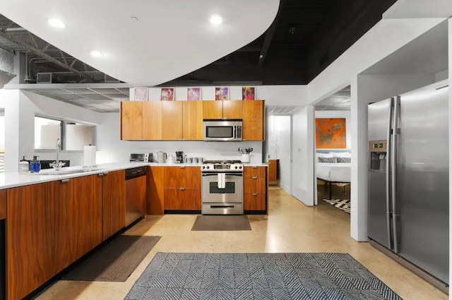 kitchen featuring a sink, light countertops, brown cabinets, and stainless steel appliances