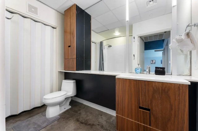 full bath with visible vents, toilet, concrete flooring, vanity, and a paneled ceiling