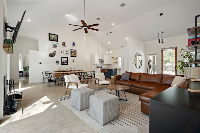 living area featuring visible vents, finished concrete floors, high vaulted ceiling, and ceiling fan