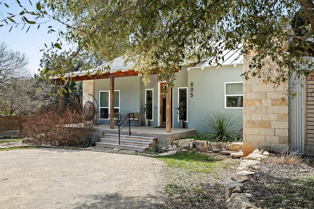 view of front of house with covered porch and stucco siding