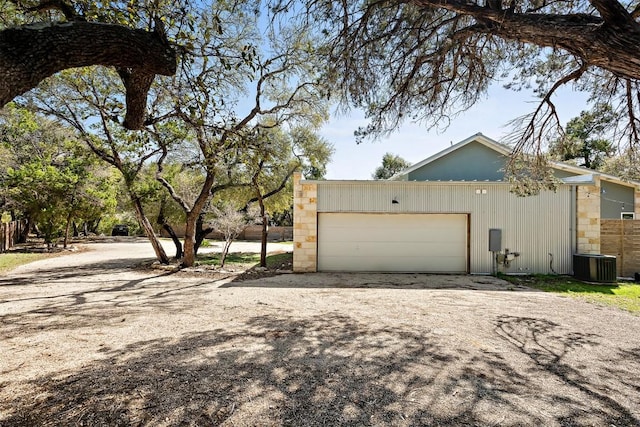 garage with driveway and central AC