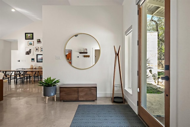 entrance foyer with baseboards and finished concrete floors