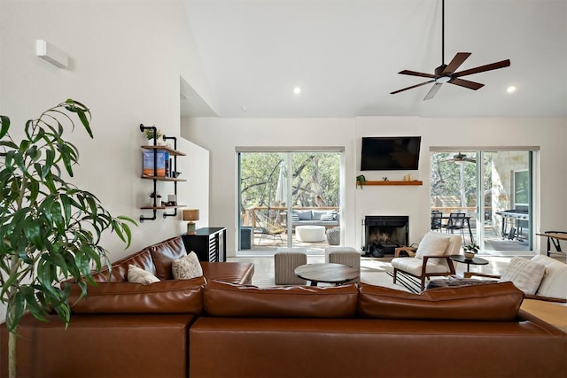 living room with recessed lighting, a fireplace, high vaulted ceiling, and ceiling fan