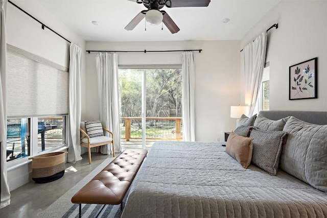 bedroom with access to exterior, concrete floors, and ceiling fan