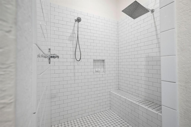 bathroom with a tile shower