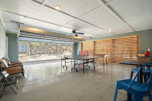 game room with speckled floor and a ceiling fan