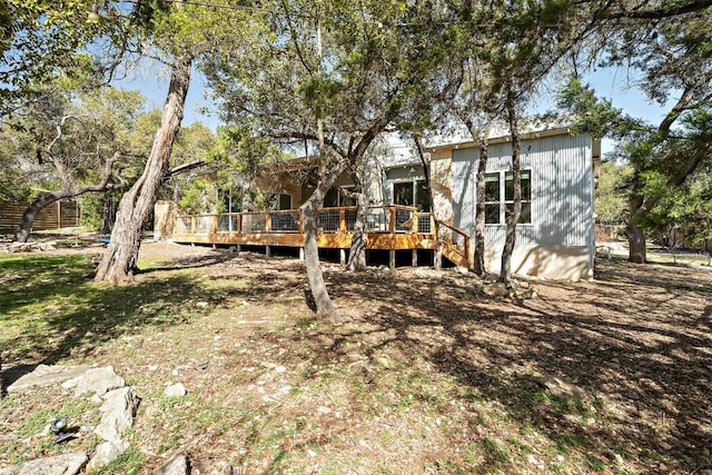 rear view of house with a wooden deck