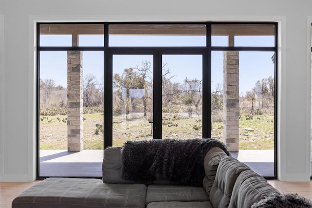 doorway featuring baseboards and light wood-style floors