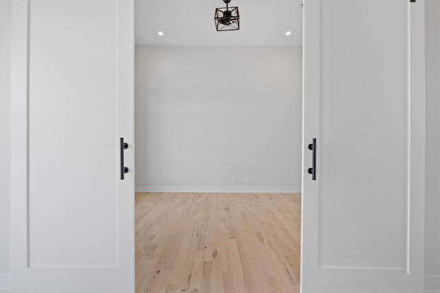 hall with recessed lighting, baseboards, and wood finished floors