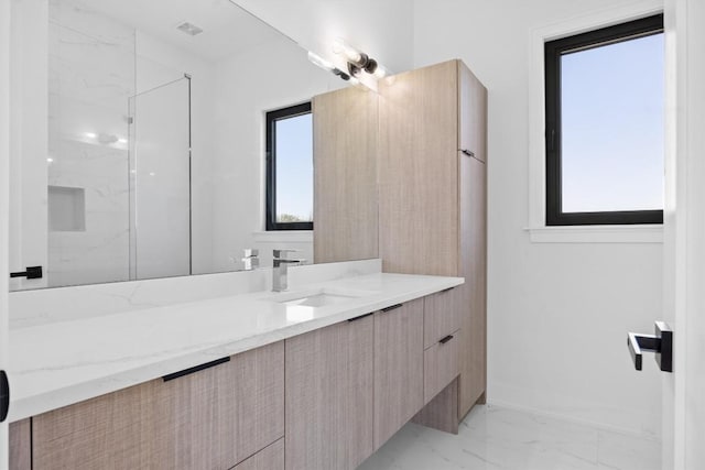 bathroom featuring visible vents, marble finish floor, a marble finish shower, baseboards, and vanity