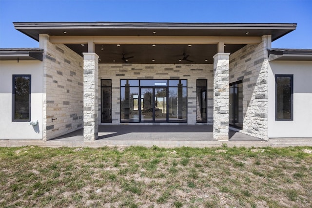 rear view of house featuring stucco siding, a patio, and ceiling fan