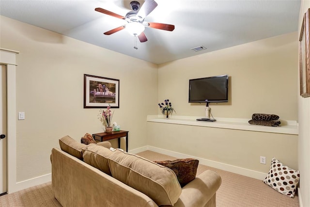 living area with a ceiling fan, visible vents, carpet floors, and baseboards