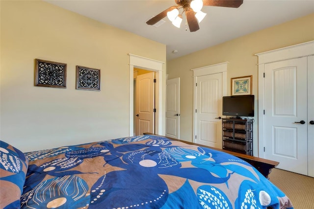 bedroom with a closet, ceiling fan, and carpet